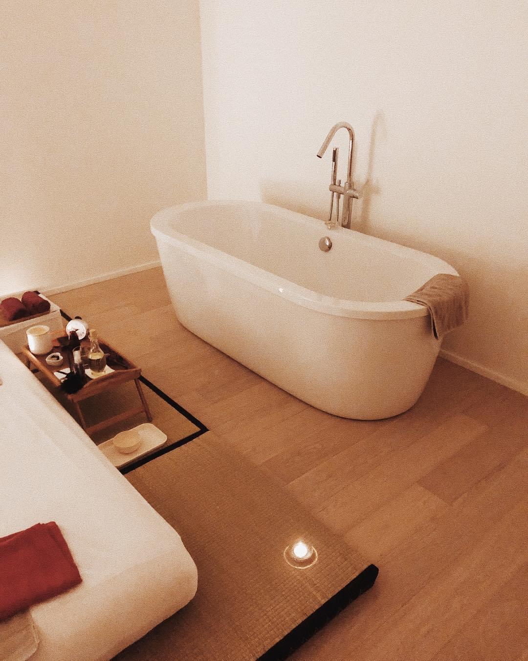 Serene freestanding bathtub in a softly lit spa room
