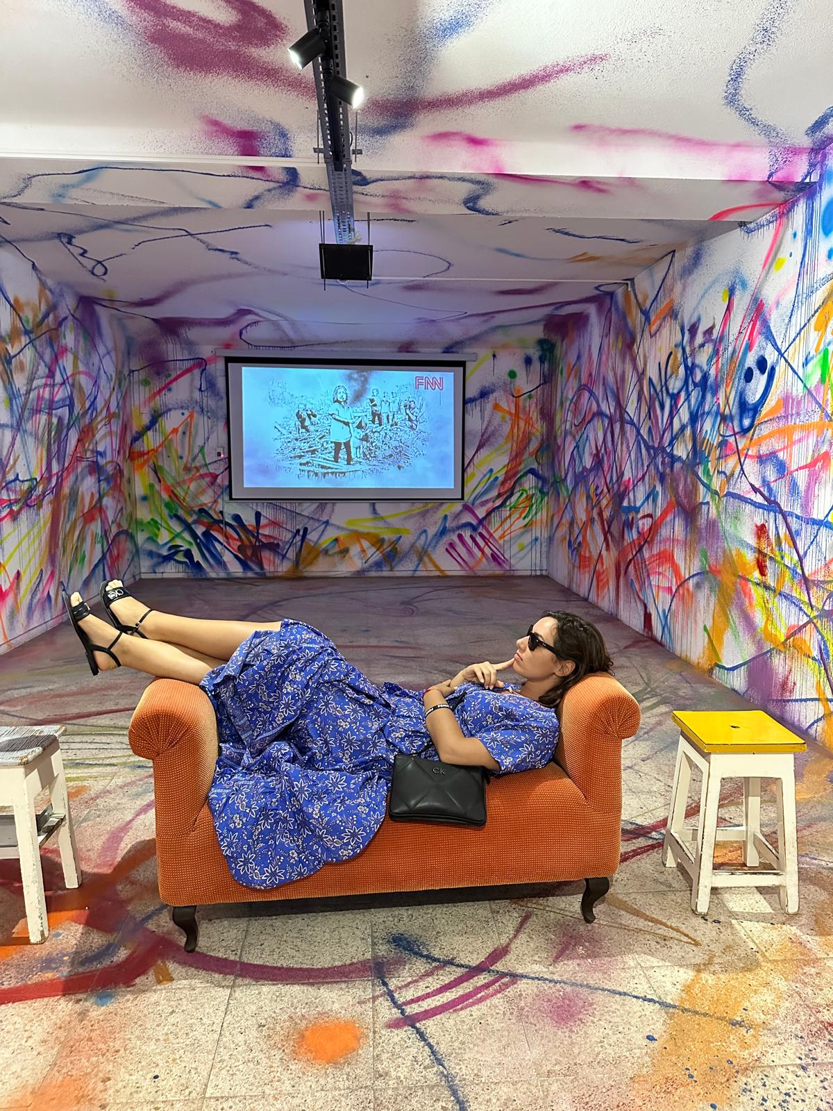 Wide view of the colourful graffiti room with the couch